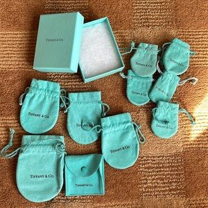 Authentic Tiffany & Co. dust bags and box.